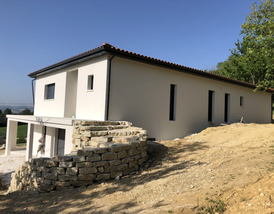 Construction d'une maison toute neuve avec façade blanche et toiture grise, porche terrasse par BELCASTRO.